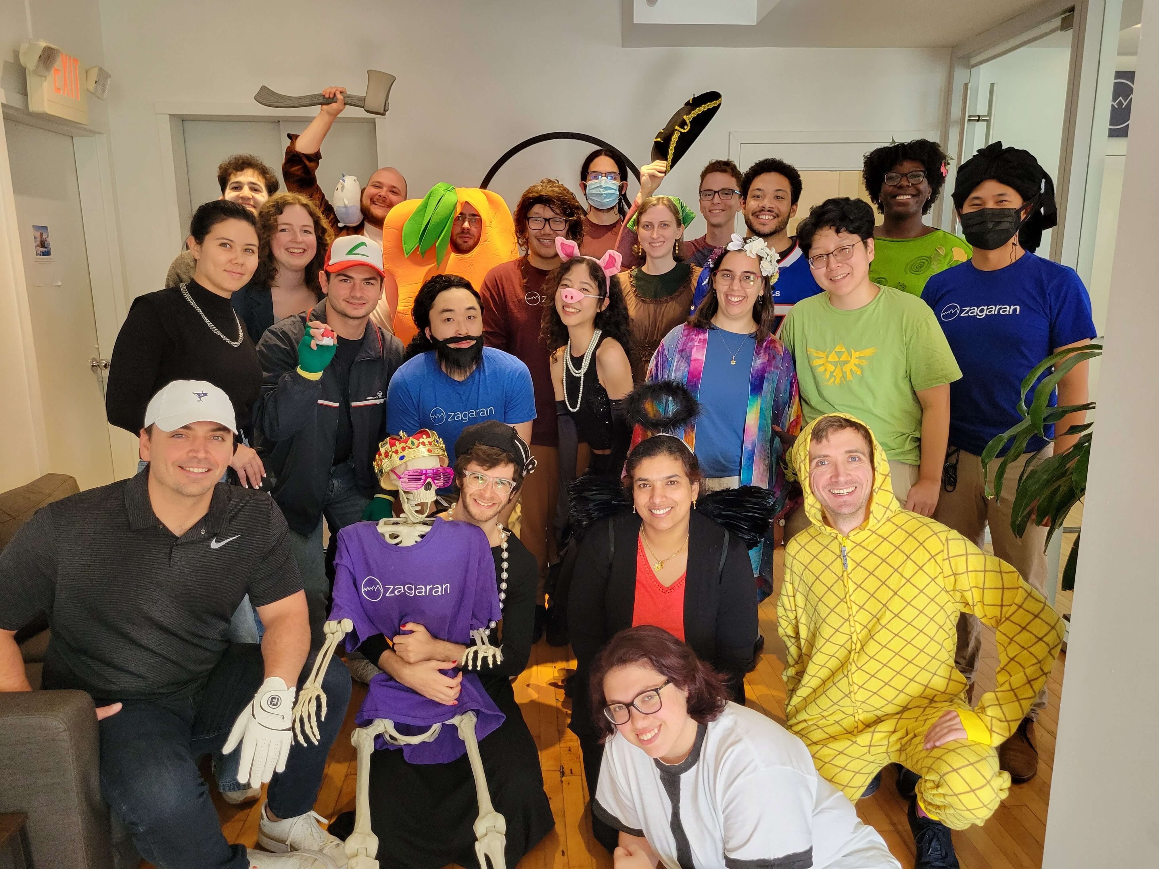 Zagaran employees on halloween ft. pineapple costumes, a skeleton in a zagaran tee, and multiple employees dressed up as the CTO